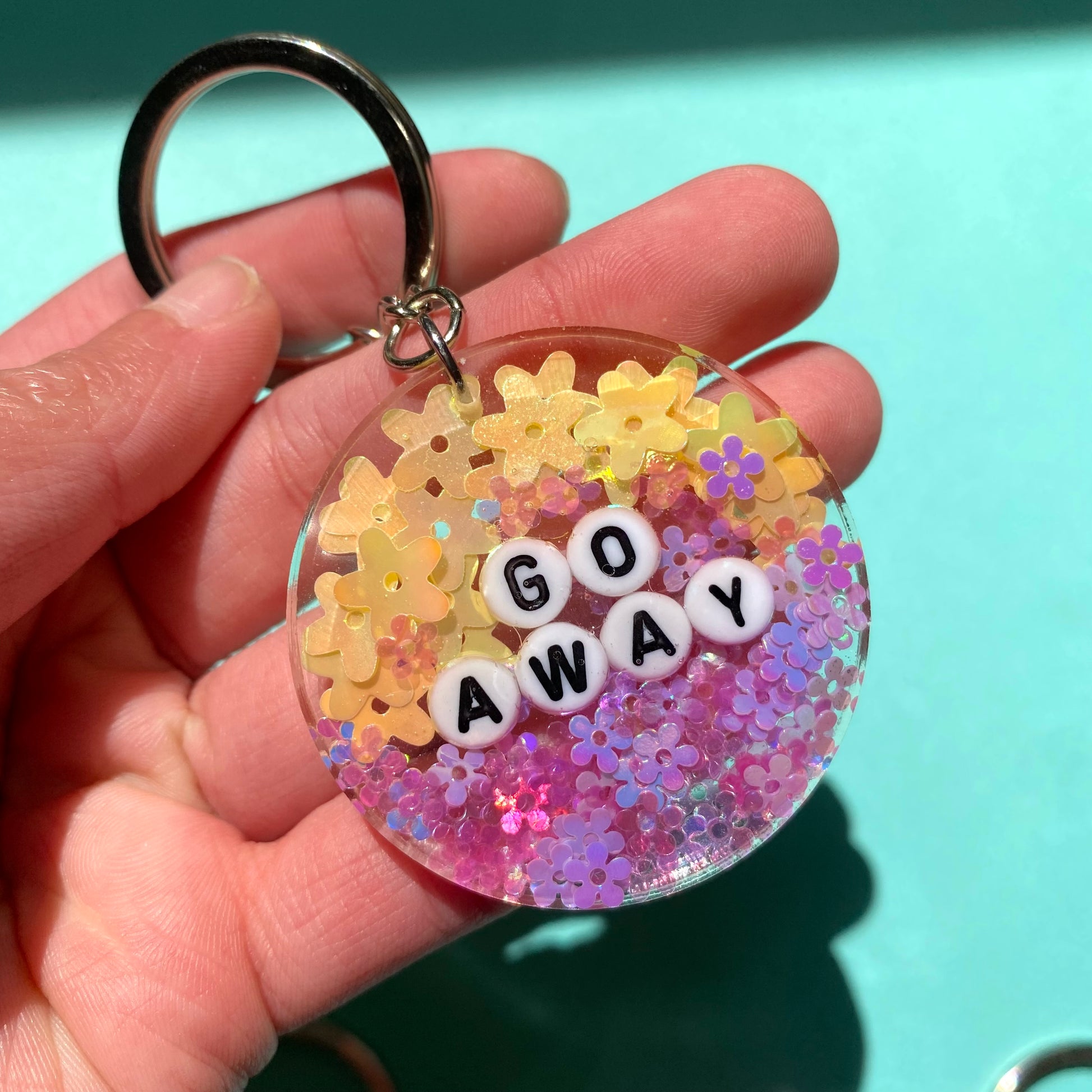 "Go Away" Yellow and purple keychain with silver key ring